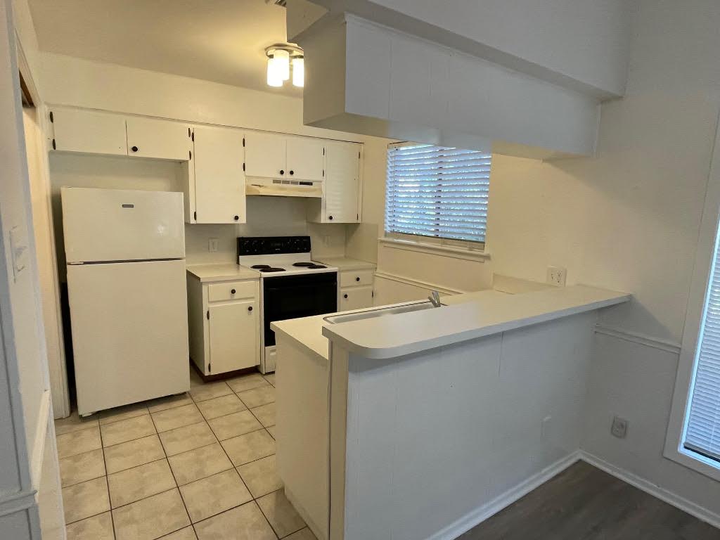 8105 Ceberry Drive, Unit B Austin, TX 78759 - Photo 9 of 12 a kitchen with a sink a stove a refrigerator and a cabinets