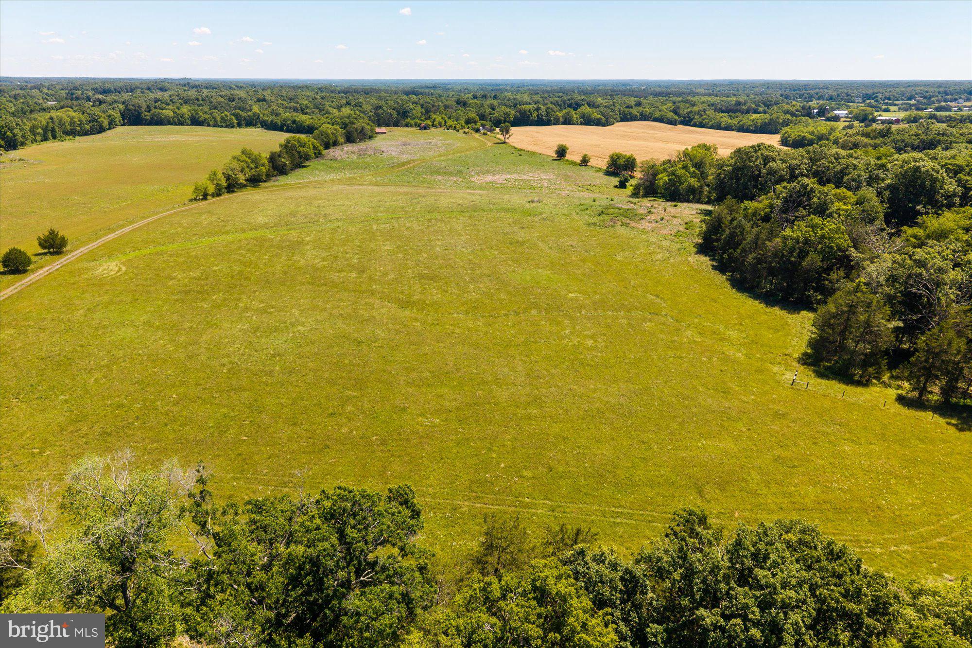 4700 Midland Road Midland, VA 22728 - Photo 12 of 31 Vast green fields under a clear sky.