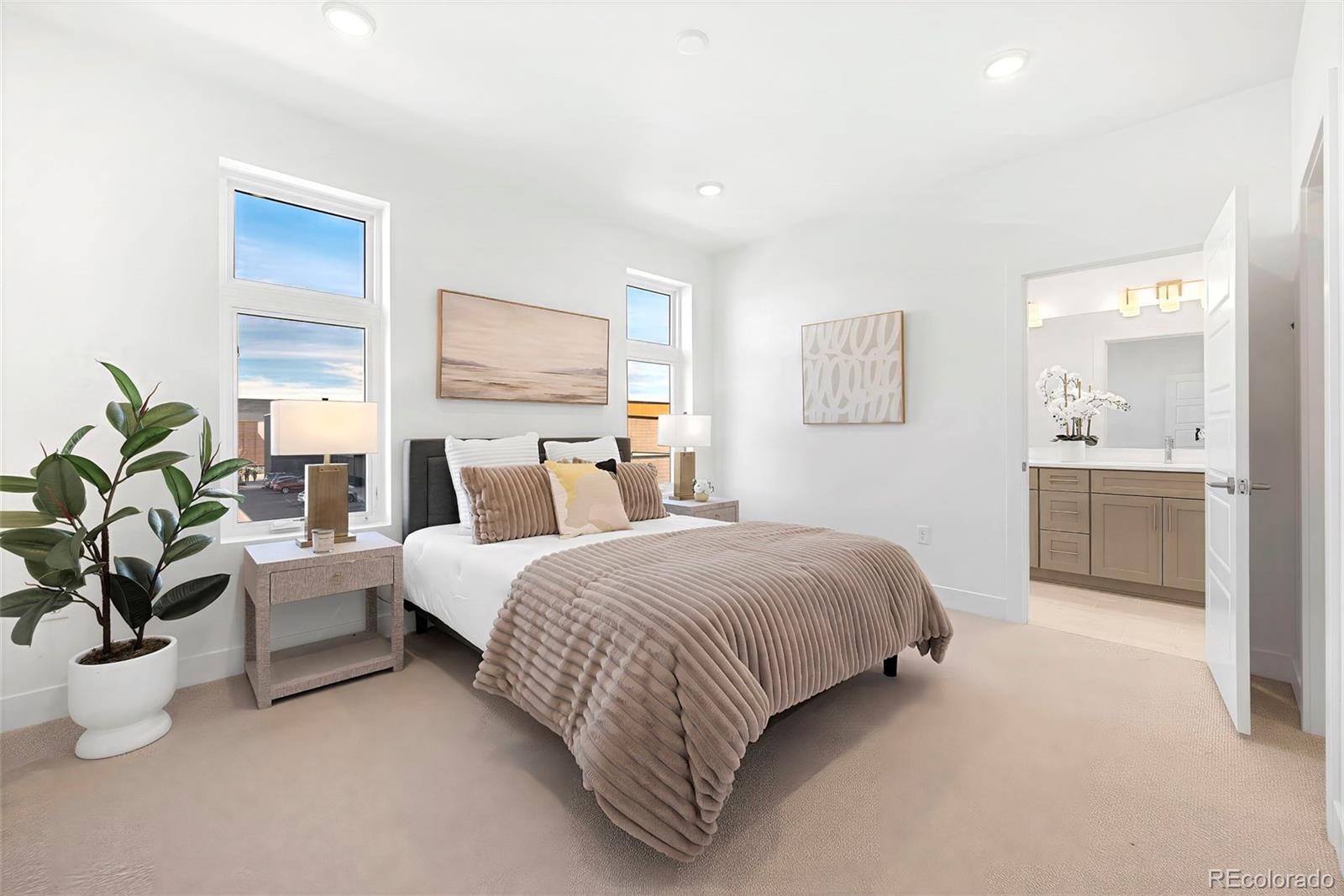 16 Oneida Court Denver, CO 80230 - Photo 12 of 19 a spacious bedroom with a bed and a couch