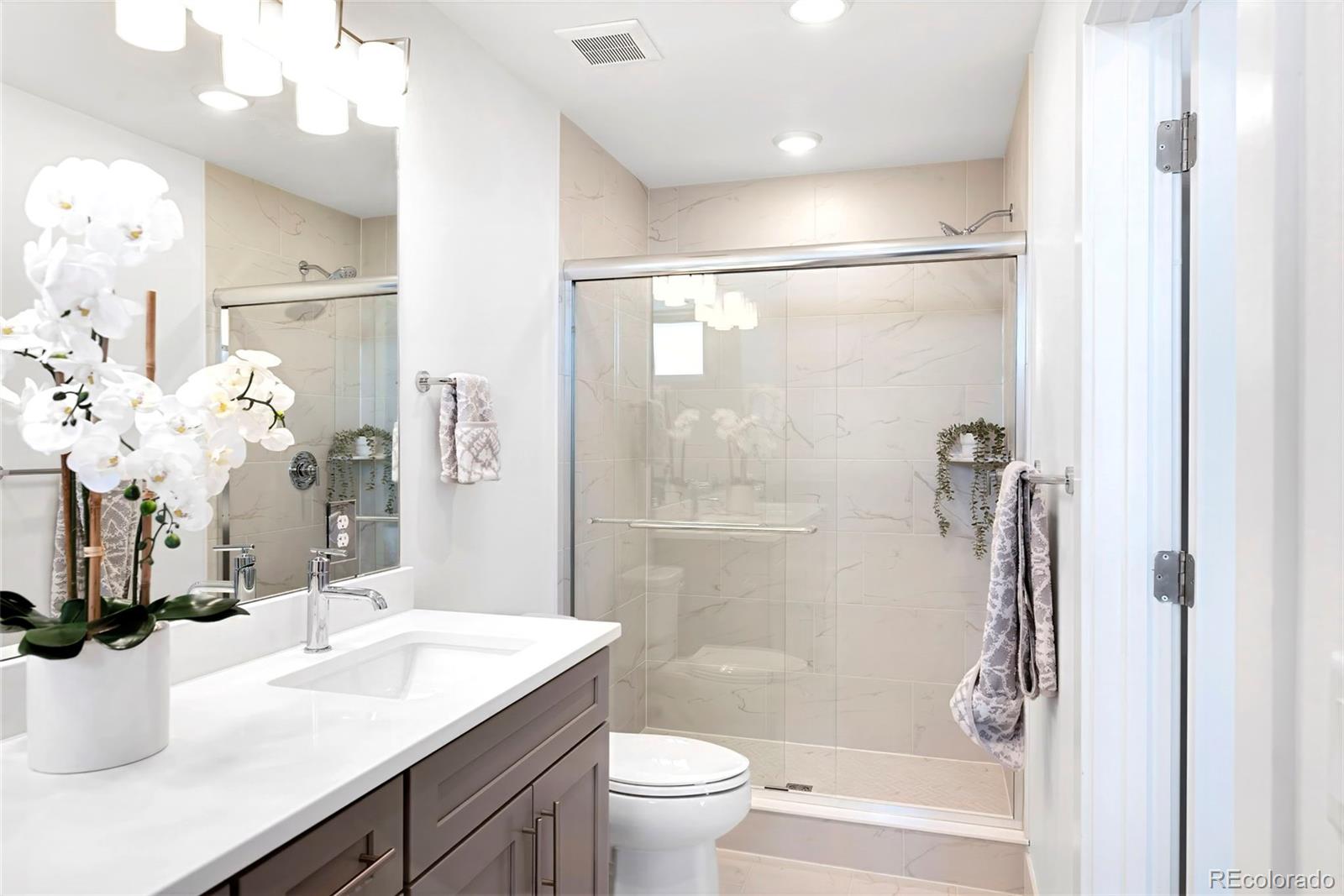 16 Oneida Court Denver, CO 80230 - Photo 13 of 19 a bathroom with a sink a toilet and shower