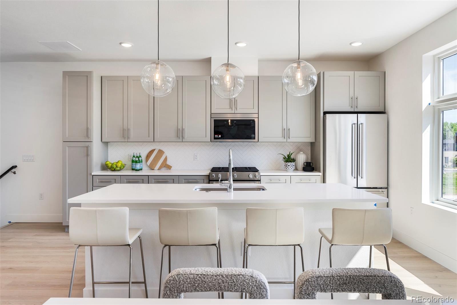 16 Oneida Court Denver, CO 80230 - Photo 2 of 19 a kitchen with stainless steel appliances granite countertop a sink a microwave a refrigerator and a stove
