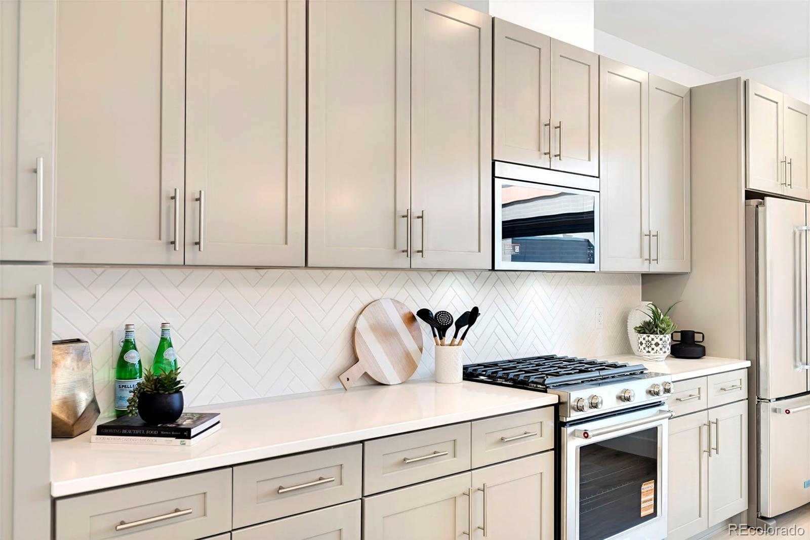 16 Oneida Court Denver, CO 80230 - Photo 7 of 19 a kitchen with stainless steel appliances white cabinets and a stove