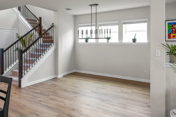 a view of hallway with wooden floor and stairs