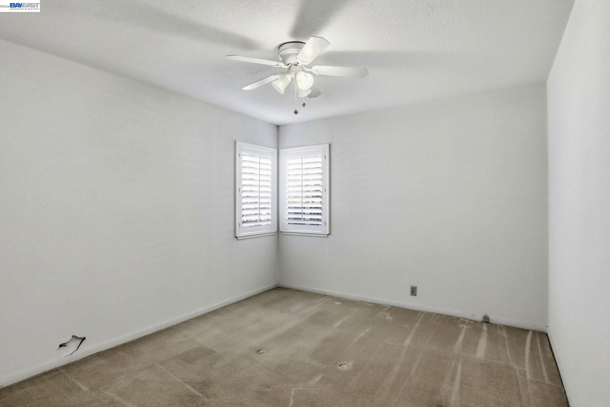 559 Cherry Way Hayward, CA 94541 - Photo 19 of 50 an empty room with a window and a fan