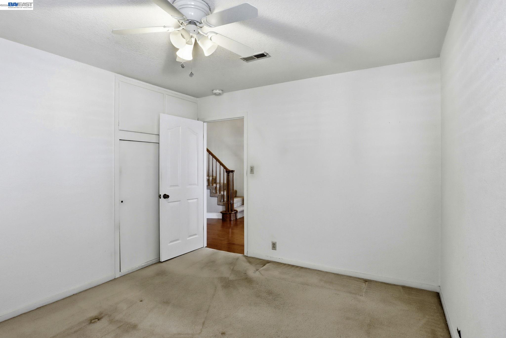 559 Cherry Way Hayward, CA 94541 - Photo 20 of 50 an empty room with a chandelier fan and closet area