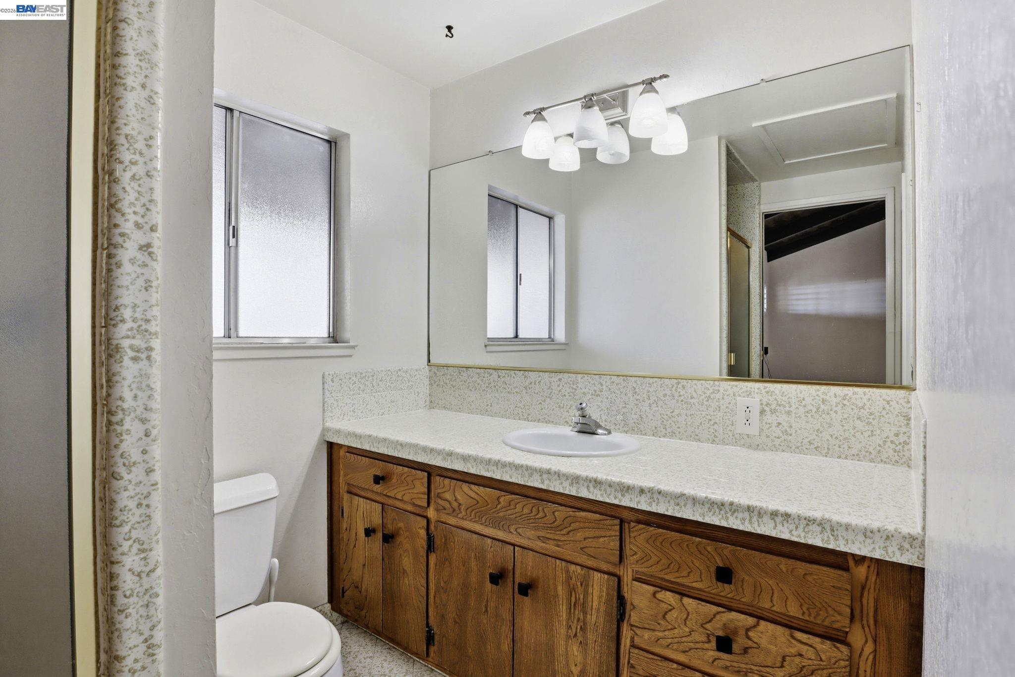 559 Cherry Way Hayward, CA 94541 - Photo 31 of 50 a bathroom with a toilet sink and mirror