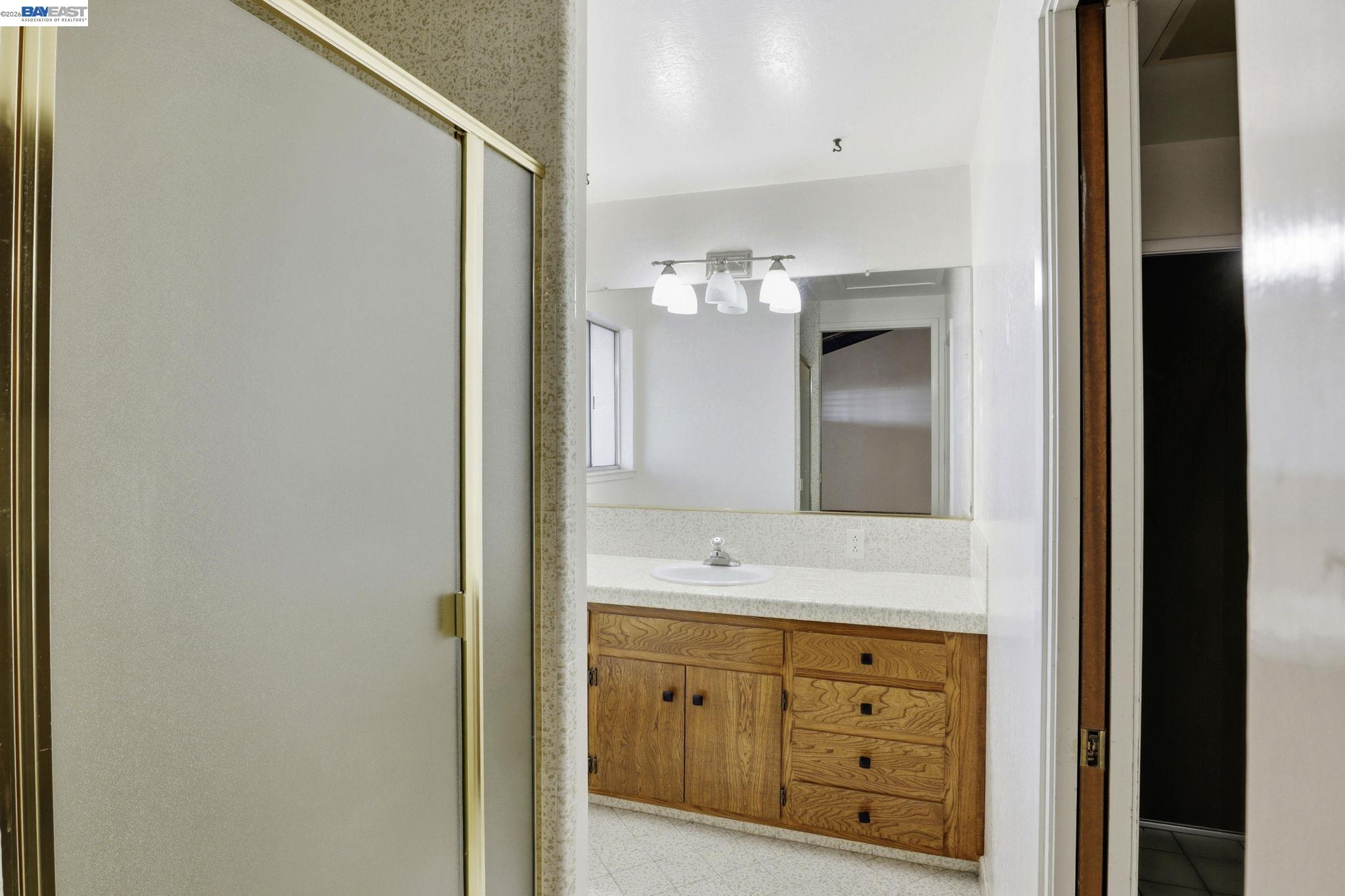 559 Cherry Way Hayward, CA 94541 - Photo 33 of 50 a bathroom with a double vanity sink and mirror with shower