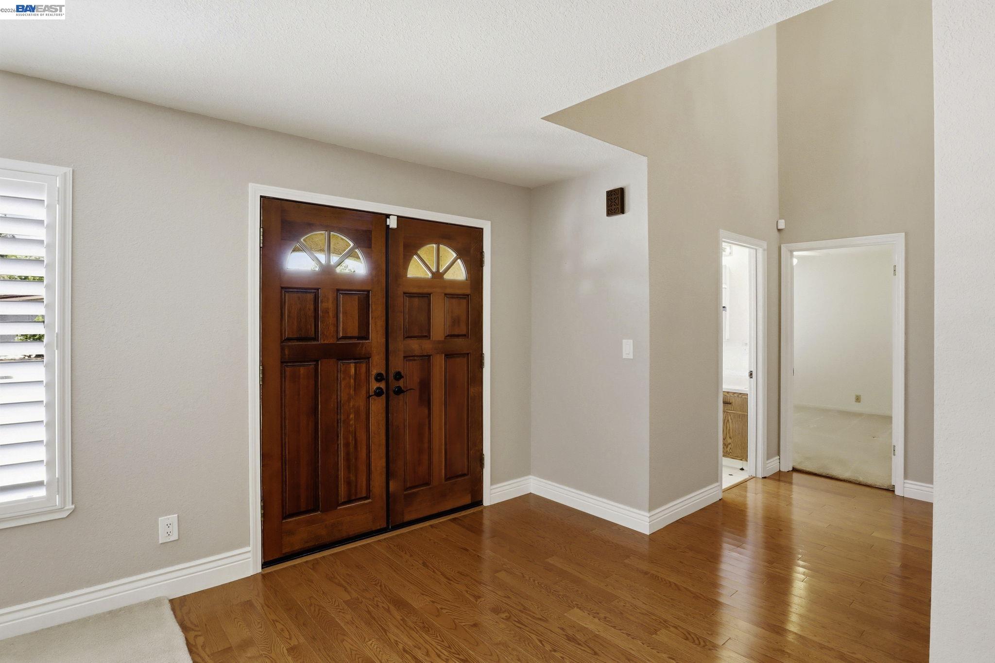 559 Cherry Way Hayward, CA 94541 - Photo 4 of 50 an empty room with wooden floor and windows