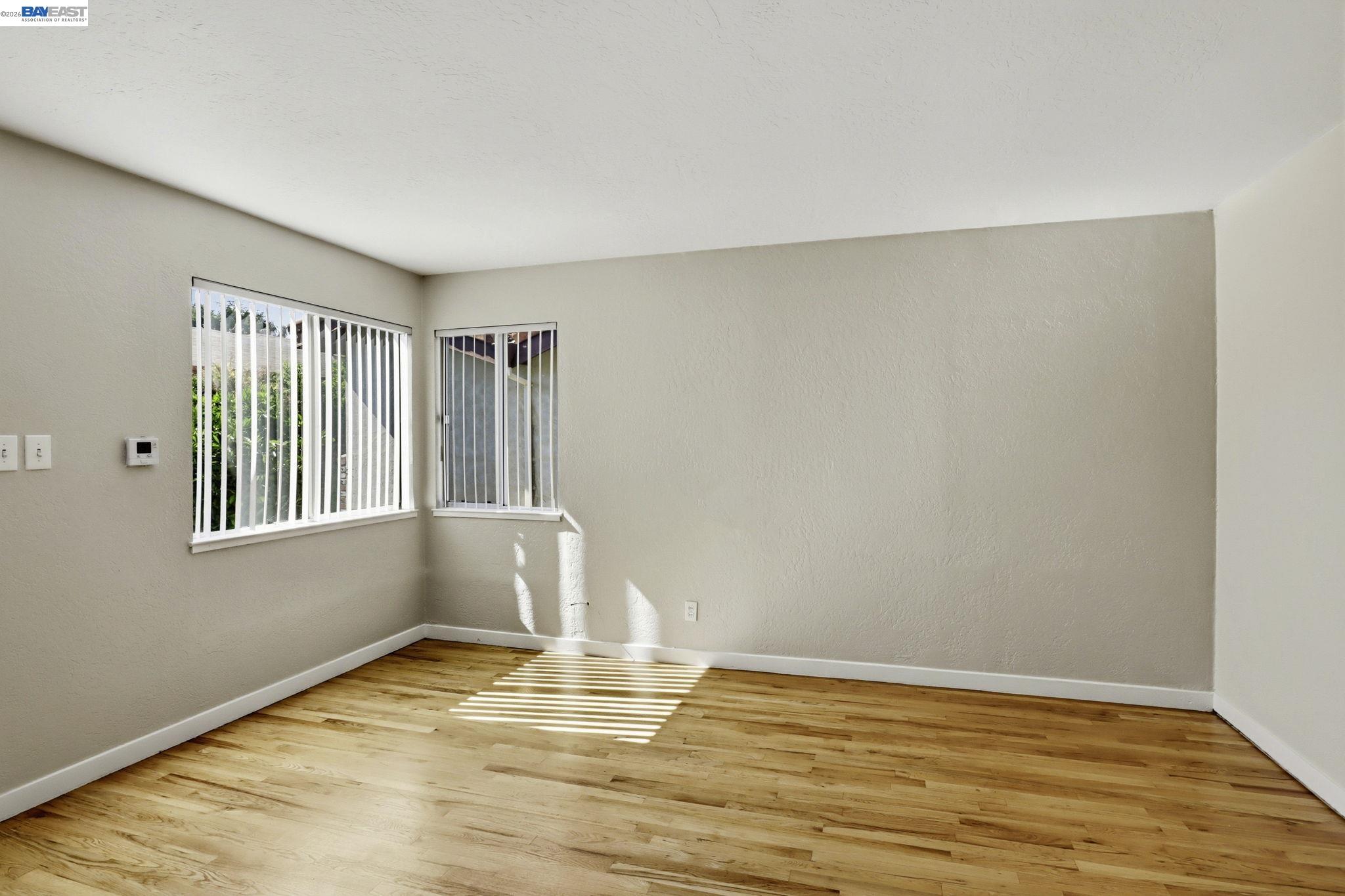 559 Cherry Way Hayward, CA 94541 - Photo 41 of 50 a view of an empty room with wooden floor and a window