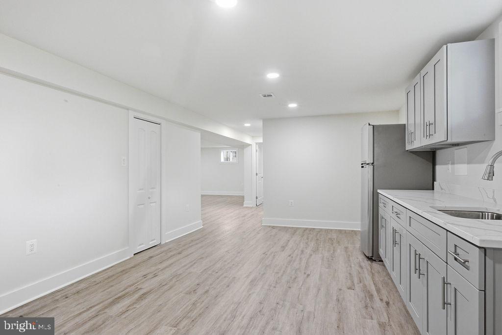 6620 Napoli Road Temple Hills, MD 20748 - Photo 24 of 38 a view of a kitchen with a sink and wooden floor