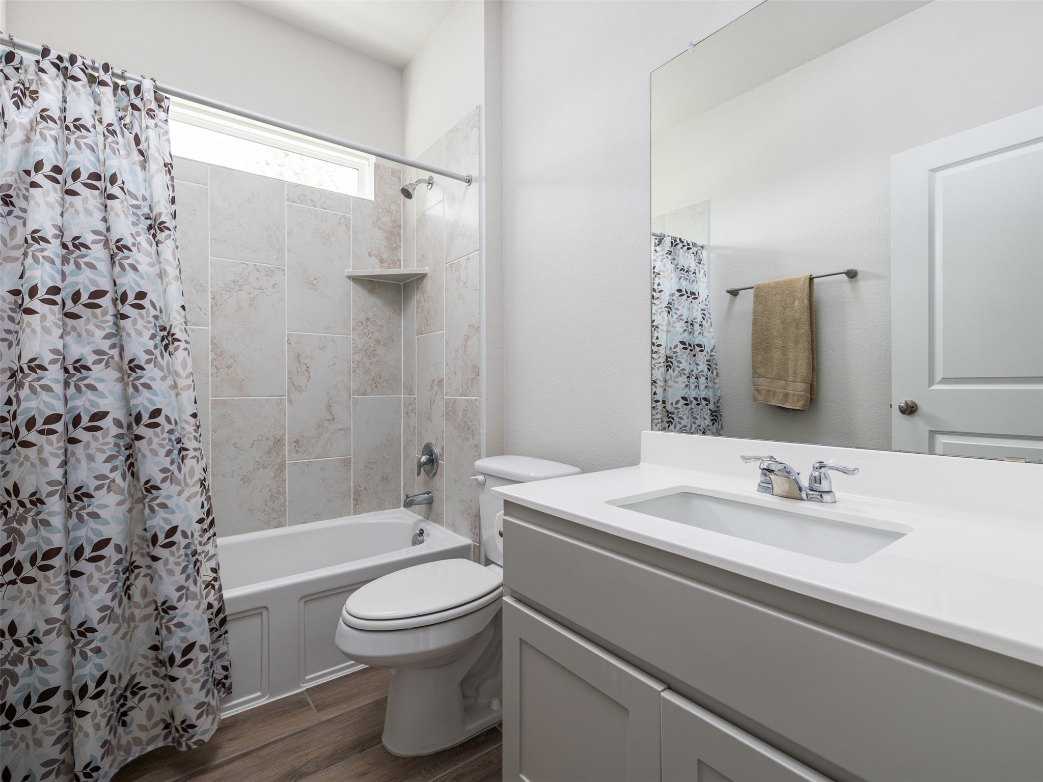 245 Brooks Ranchi Drive Kyle, TX 78640 - Photo 12 of 16 Full bathroom with vanity, shower / tub combo with curtain, and dark wood finished floors