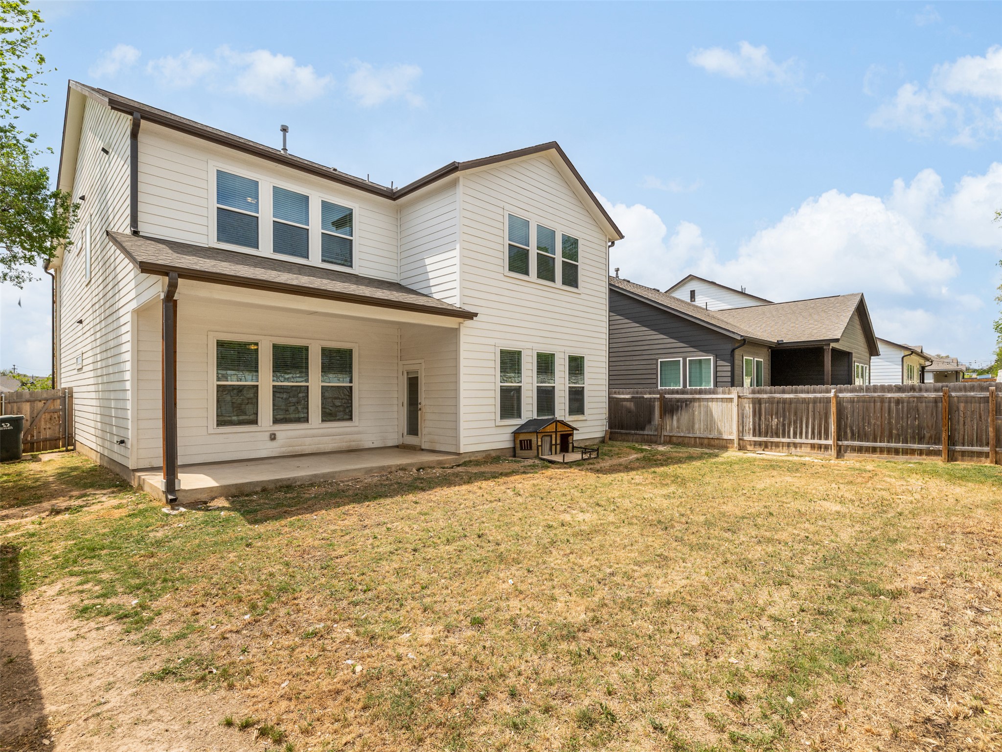 245 Brooks Ranchi Drive Kyle, TX 78640 - Photo 14 of 16 Back of house featuring a patio area and a fenced backyard