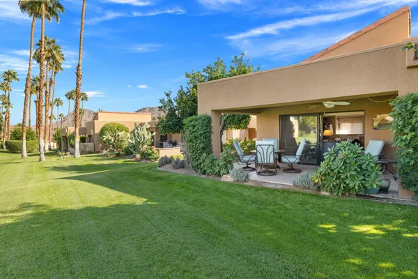 a view of a house with a backyard and a patio