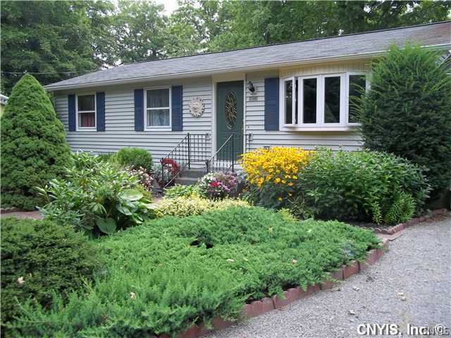 2109 Friendly Shore Road Tully, NY 13159 - Photo 1 of 1 Exterior Front. Gorgeous flower beds surround this