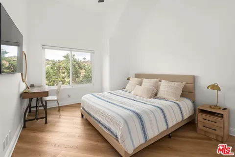 a bedroom with a bed and a table