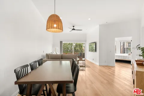 a view of a dining room with furniture and wooden floor