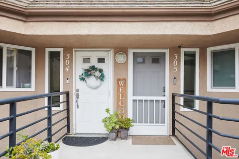 a front view of a house with a potted plant