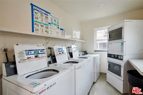 a kitchen with kitchen island a stove a sink and a microwave