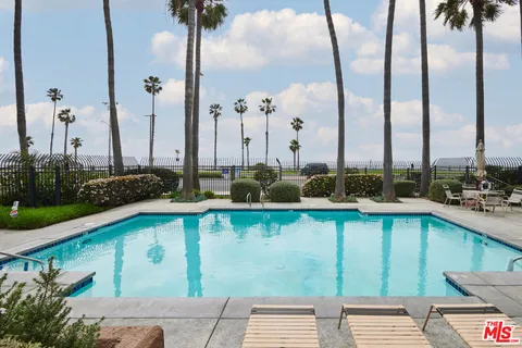 a view of a brick building with a tree in front