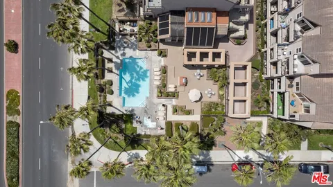 an aerial view of a residential apartment building with a yard