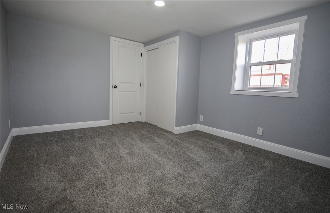 67480 Barnesville Hendrysburg Road Barnesville, OH 43713 - Photo 11 of 16 Empty room featuring dark colored carpet