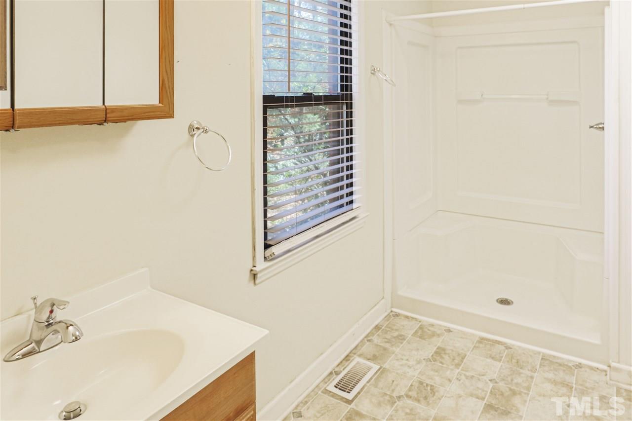 901 Merrie Road Raleigh, NC 27606 - Photo 13 of 18 a bathroom with a sink and a shower
