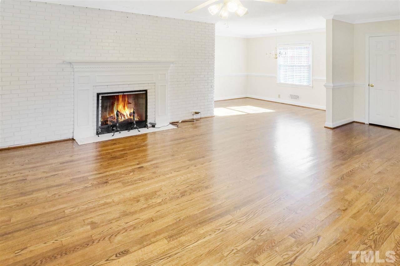 901 Merrie Road Raleigh, NC 27606 - Photo 3 of 18 a view of an empty room with wooden floor and a window