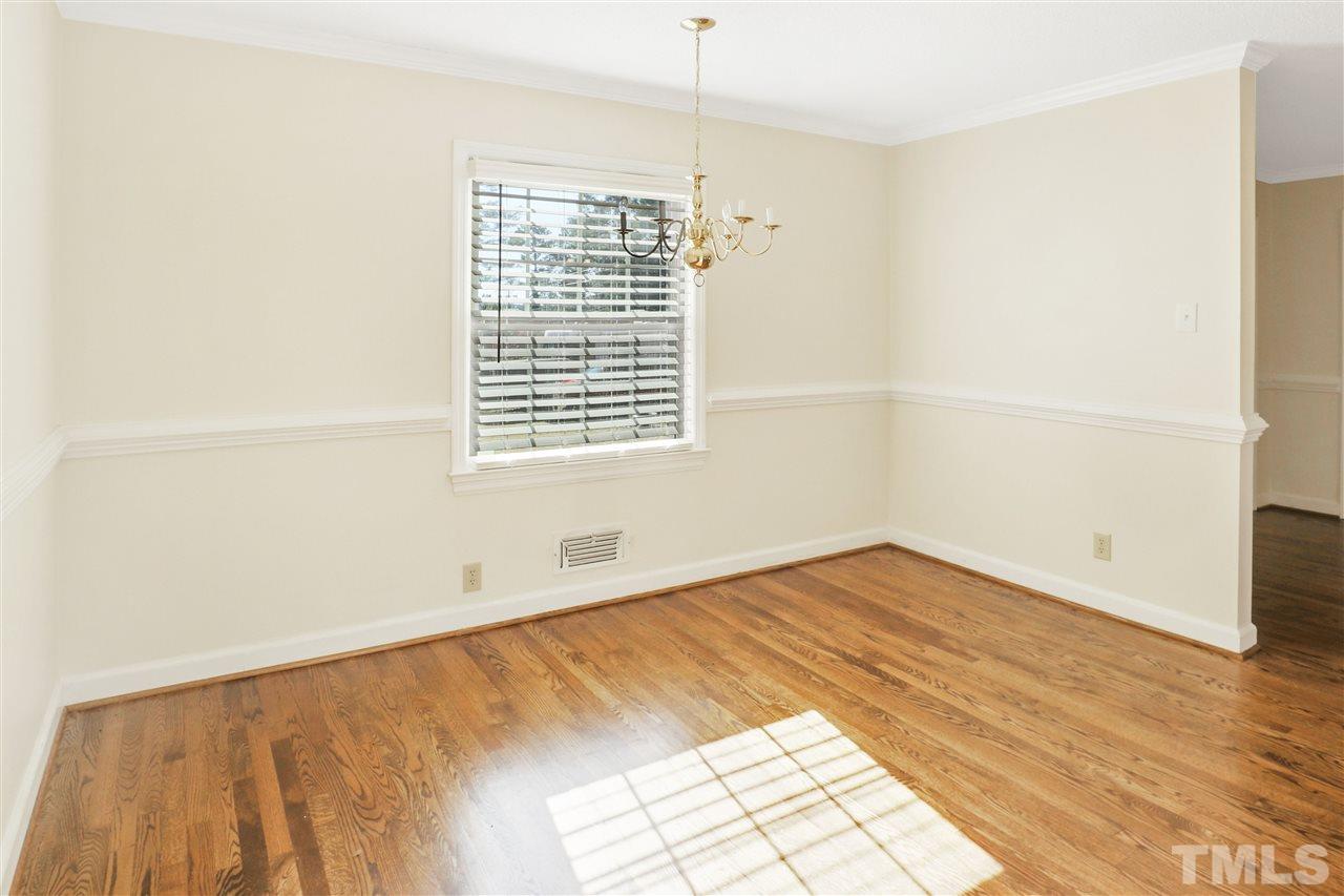 901 Merrie Road Raleigh, NC 27606 - Photo 7 of 18 a view of empty room with wooden floor and fan