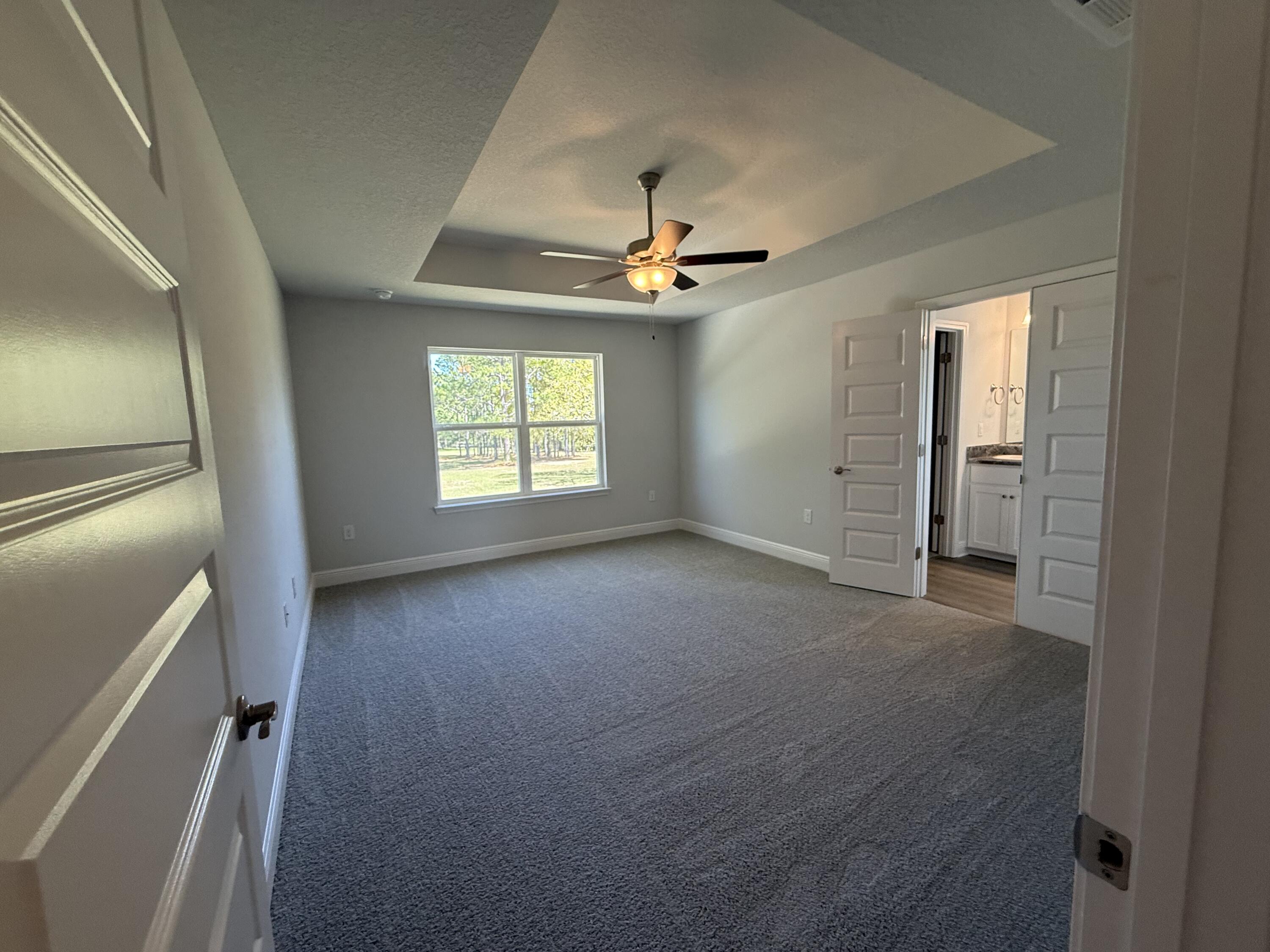 6014 Crocket Cove Crestview, FL 32539 - Photo 14 of 29 an empty room with windows and fan