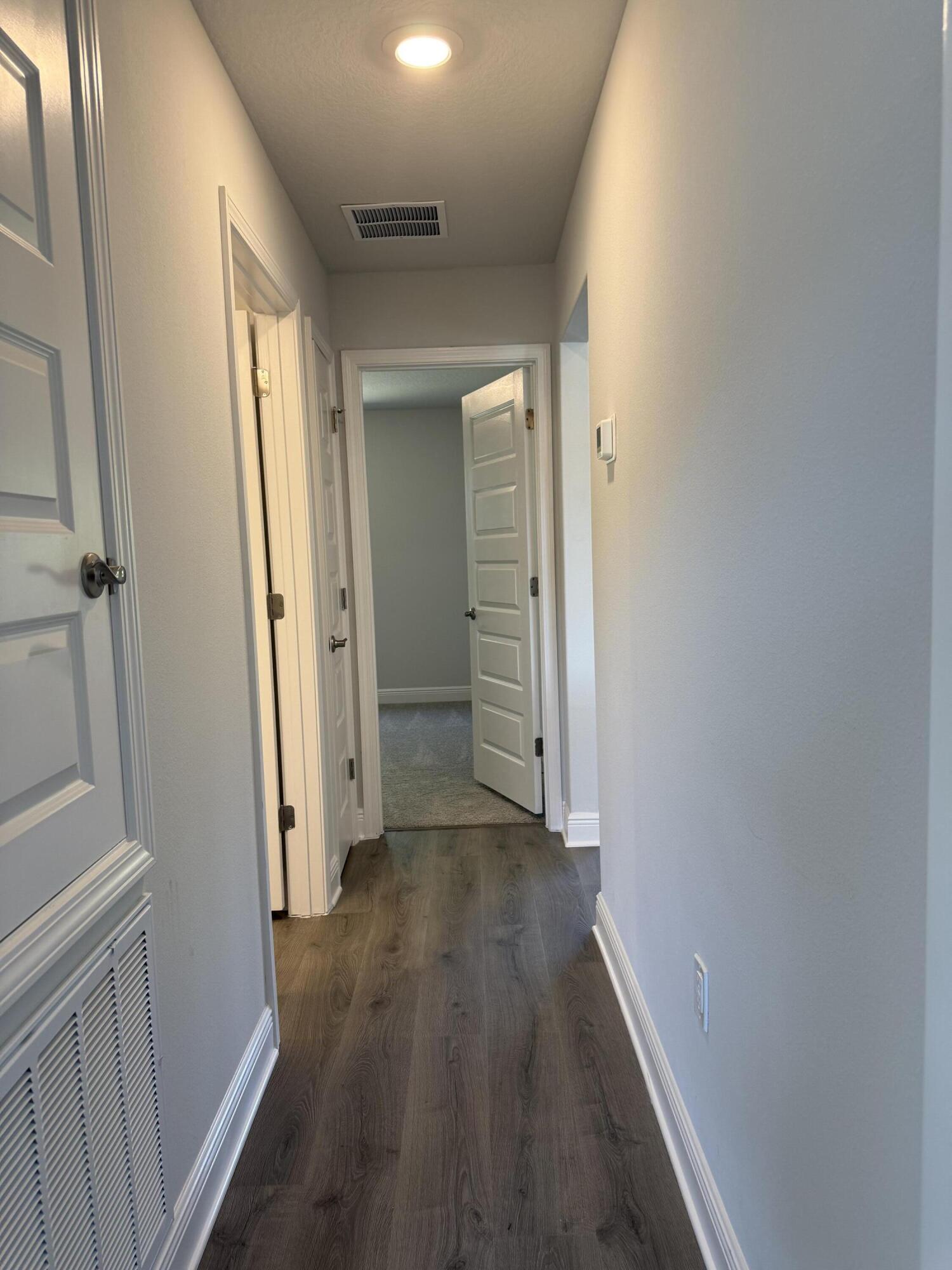 6014 Crocket Cove Crestview, FL 32539 - Photo 24 of 29 a view of a hallway with wooden floor