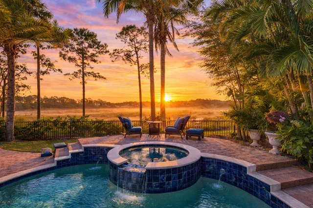 a front view of a house with garden and parking