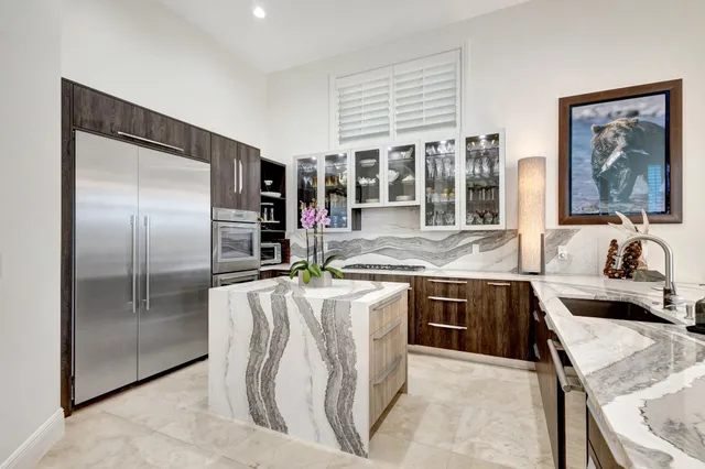 a living room with furniture a chandelier and a large window