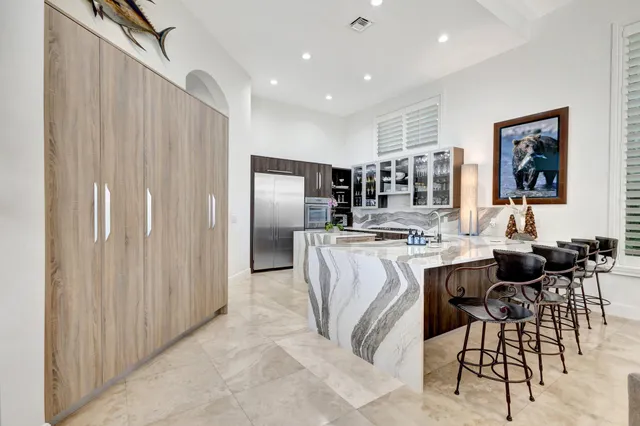a dining room with furniture a rug and a large window