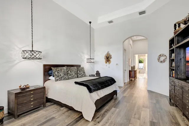a view of a swimming pool with a yard and plants