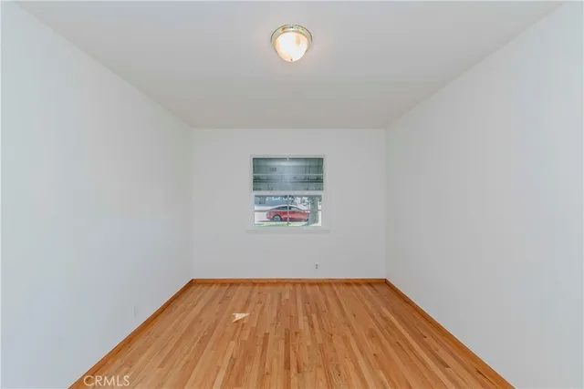 a view of a room with wooden floor and fan