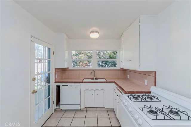 a kitchen with a stove and a window