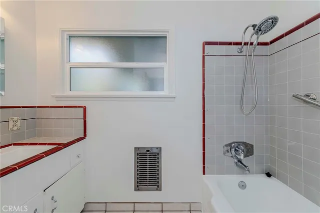 a bathroom with a bathtub and shower