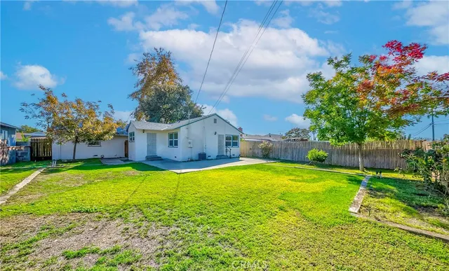 a swimming pool with yard in front of it