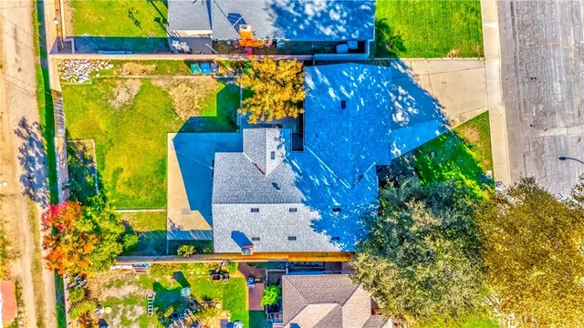 an aerial view of a houses with swimming pool