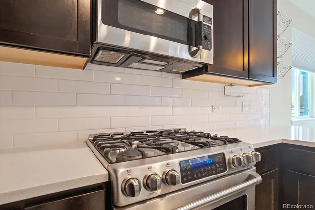 a stove top oven sitting inside of a kitchen