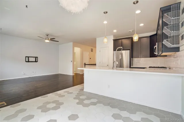 a view of kitchen and hall with wooden floor