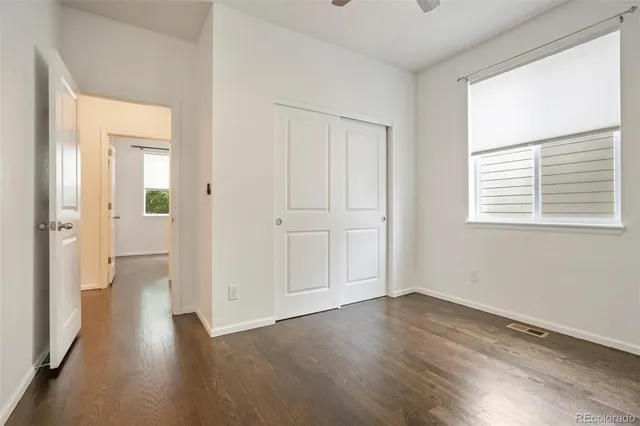 a view of a room with wooden floor and a window
