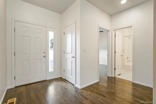 a view of an empty room and wooden floor