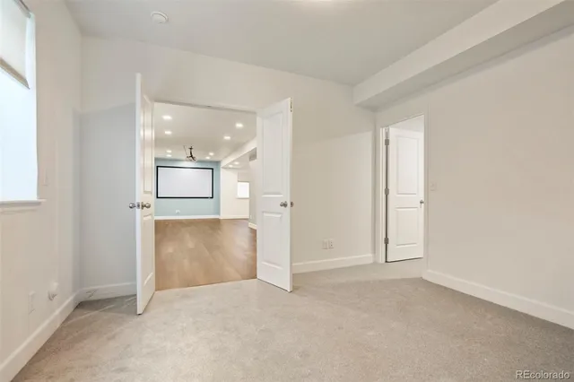 an empty room with a empty space and windows