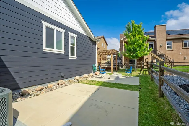 a view of a backyard with plants and a patio