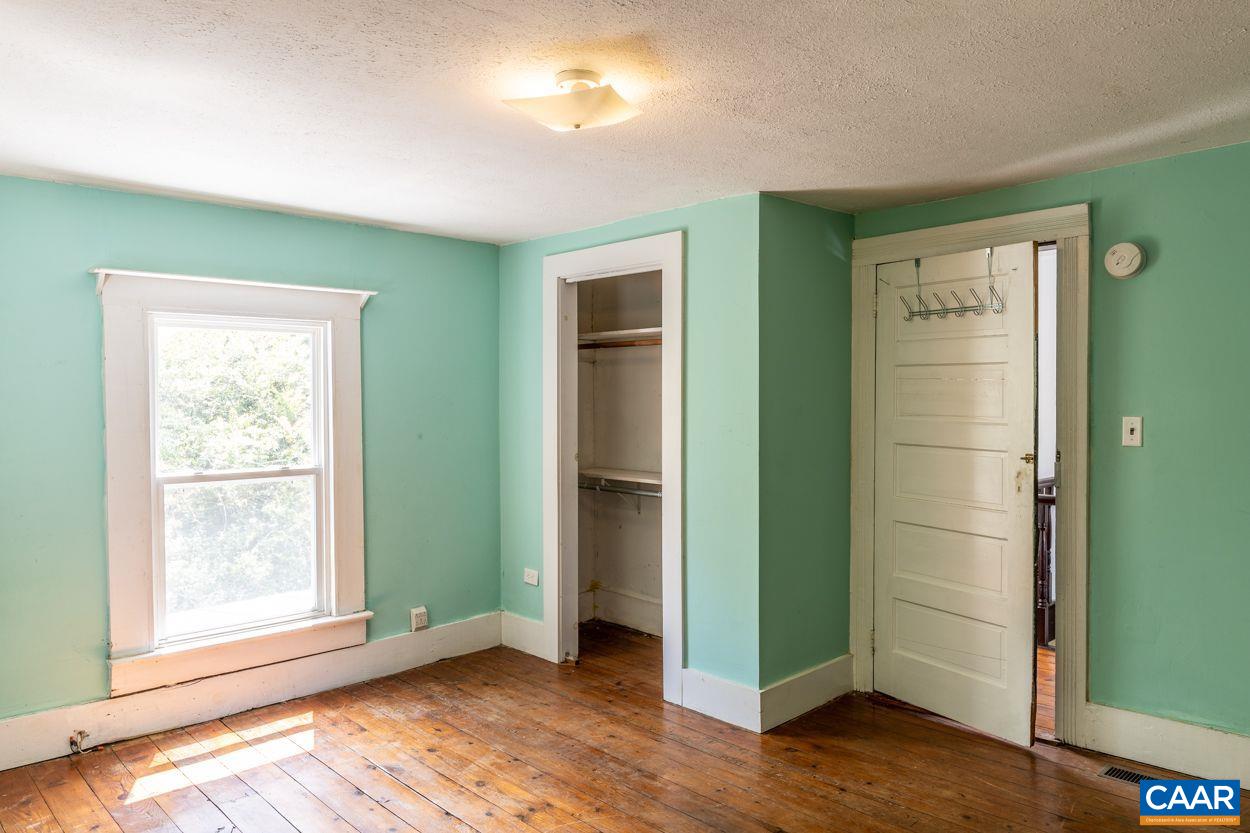 2701 Welsh Run Road Ruckersville, VA 22968 - Photo 54 of 75 a view of an empty room with wooden floor and a window
