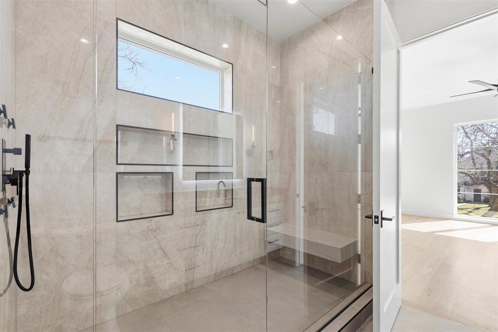 6257 Turner Way Dallas, TX 75230 - Photo 32 of 39 a bathroom with a glass shower door