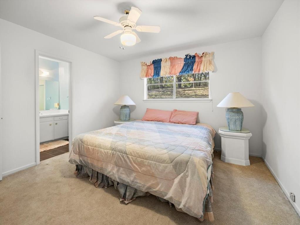 13030 Miller Road Azle, TX 76020 - Photo 20 of 40 a bedroom with a bed and a chandelier