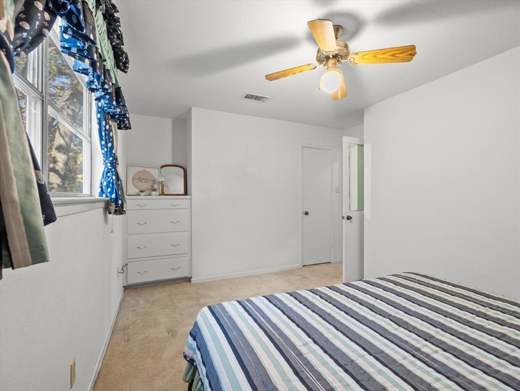 13030 Miller Road Azle, TX 76020 - Photo 23 of 40 a bedroom with a bed and a chandelier