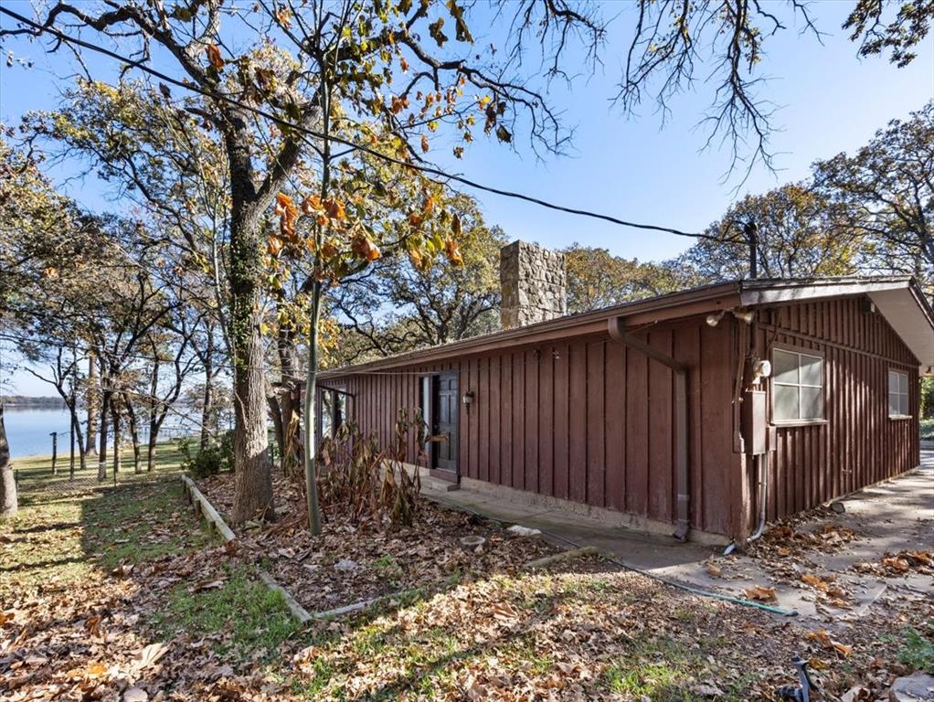 13030 Miller Road Azle, TX 76020 - Photo 29 of 40 a view of a backyard with wooden fence and large trees
